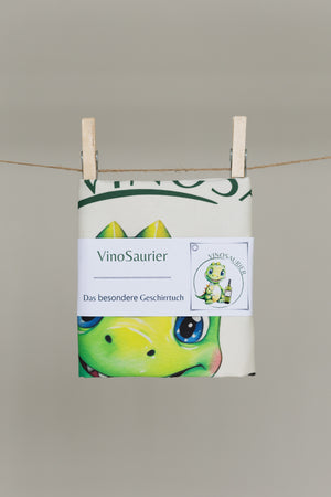 Gefaltetes nachhaltiges Geschirrtuch VinoSaurier mit hochwertiger Banderole und Dino mit Wein Motiv